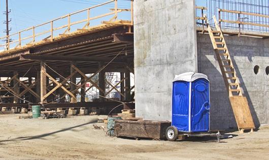 multiple portable toilets arranged at a busy work site