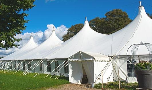 a line of portable toilets in a shaded area, offering a comfortable experience for users in Sagle